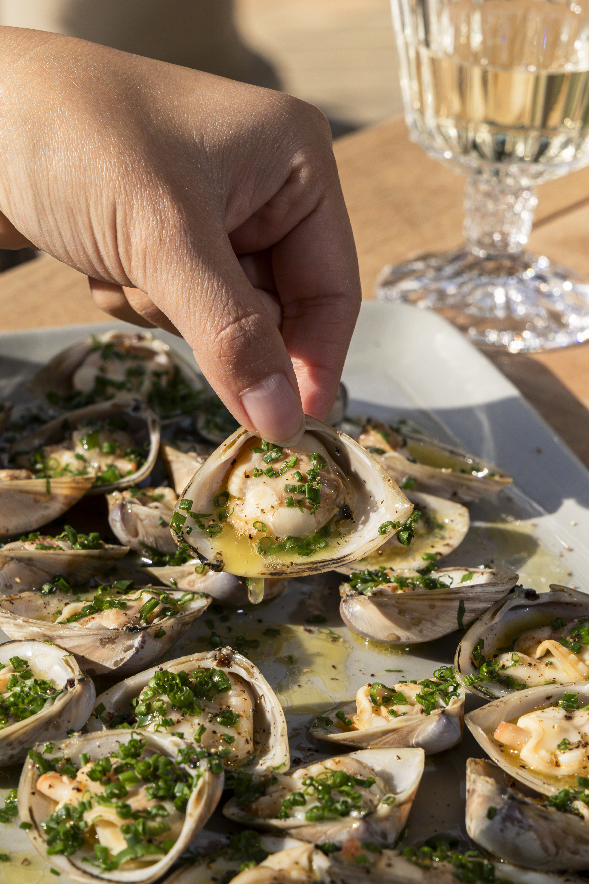Herbed Diamond Shell clams lifted from a platter