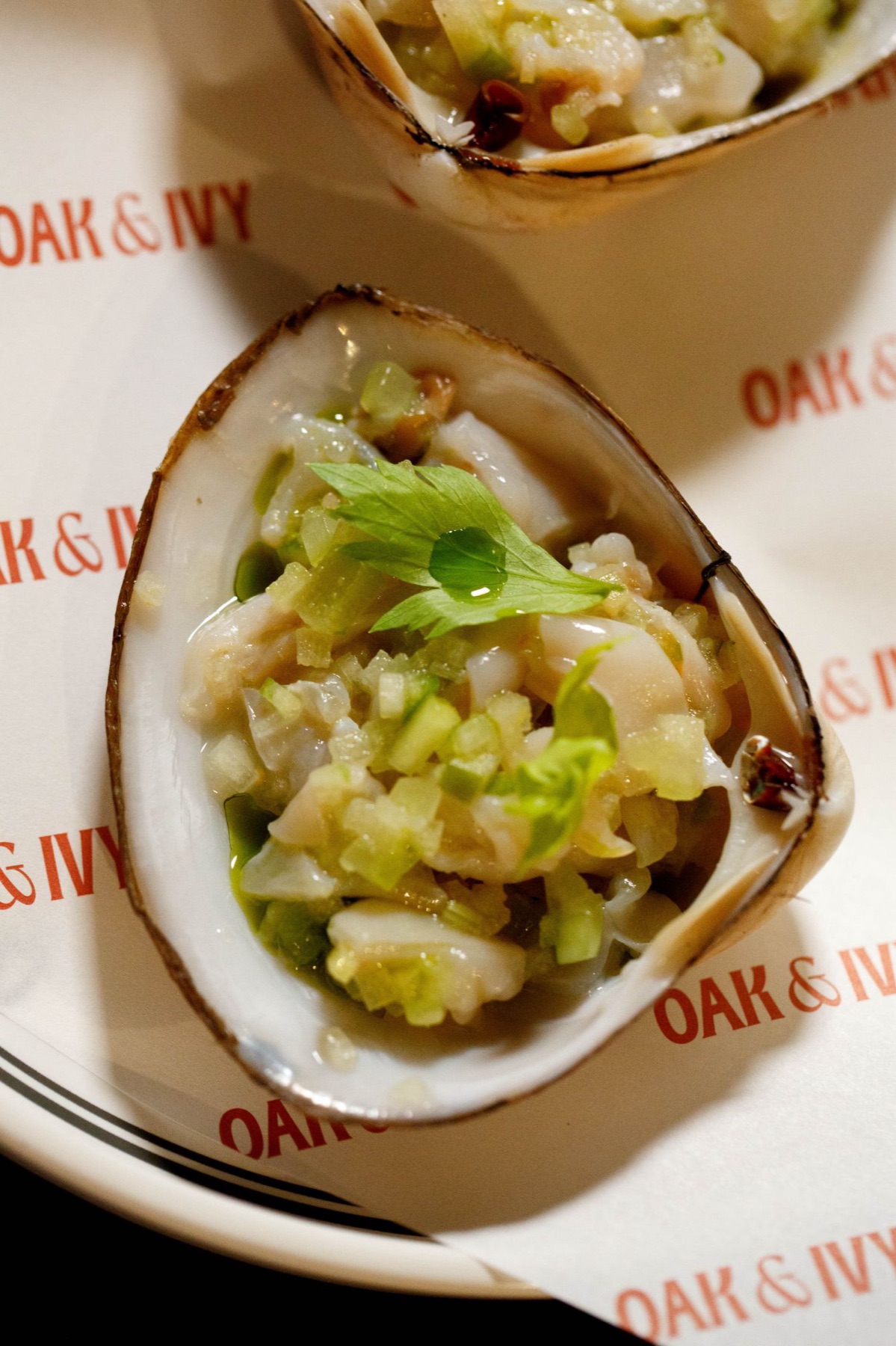 Storm Shell clam on the half shell with leche de tigre, cucumber and green apple at Oak & Ivy