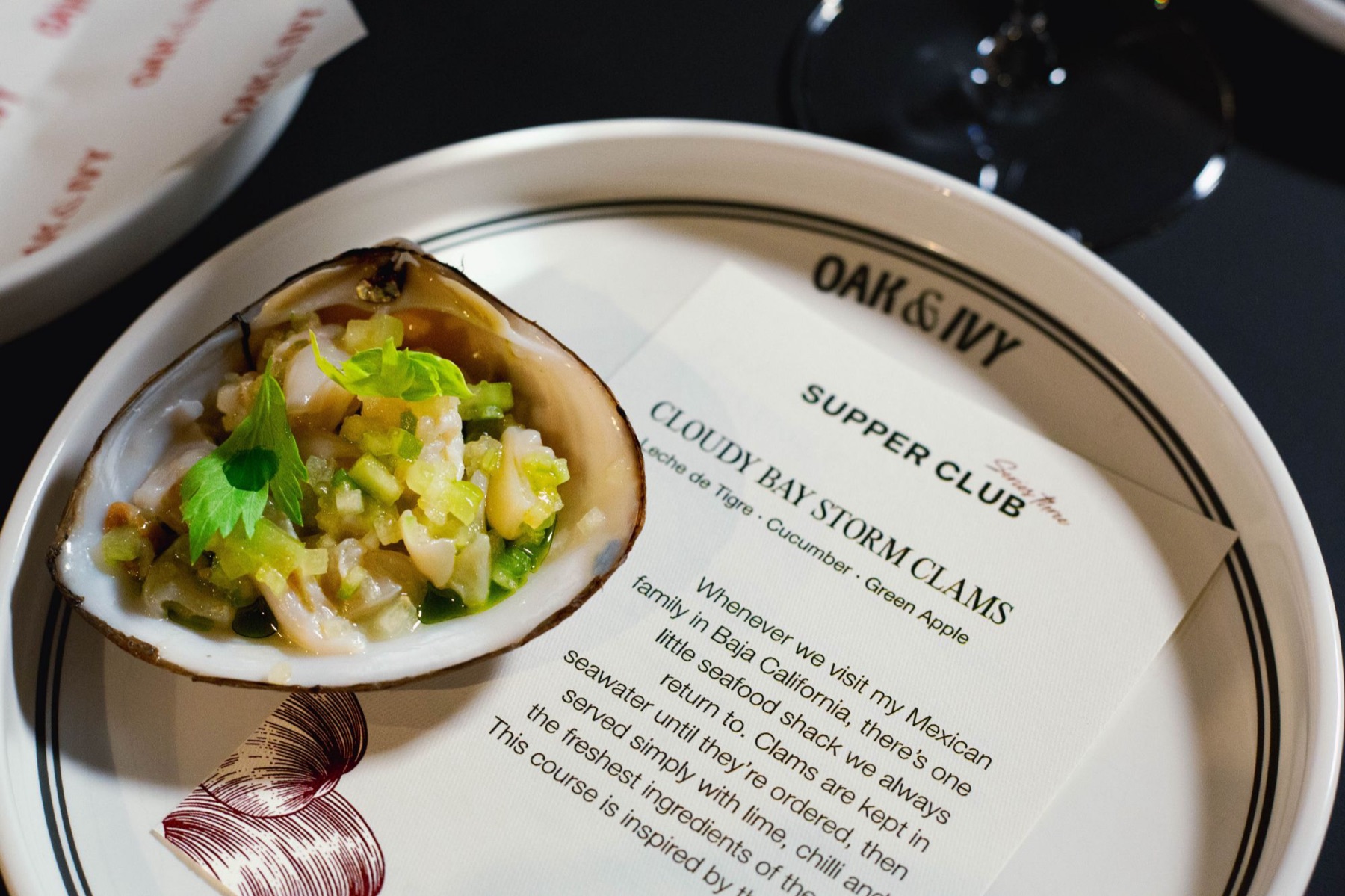 Cloudy Bay Storm Shell clam course at the Oak & Ivy Supper Club with its menu card